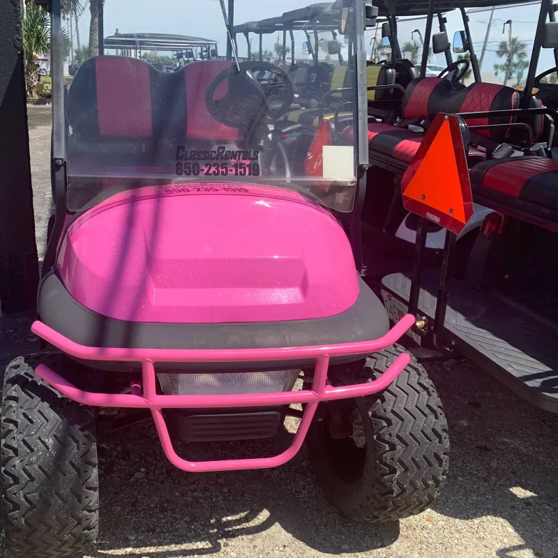 Pink lifted golf cart with a pink brush guard